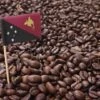 Organic Papua New Guinea 2lb Coffee Beans -Coffee Related Shop flag of Papua New Guinea sticking in roasted coffee beans Per Bengtsson Shutterstock